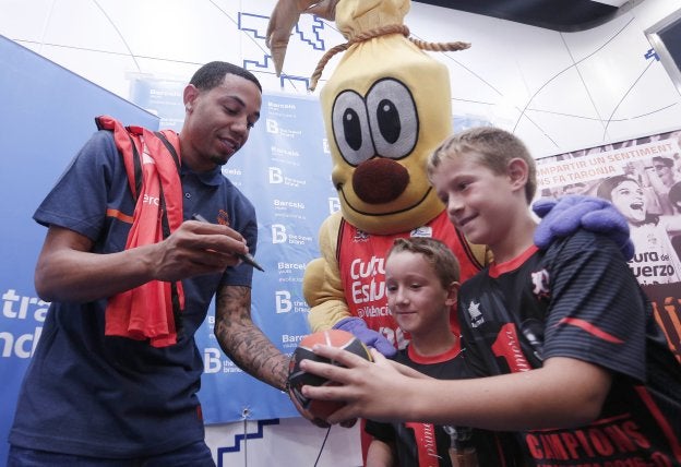 El estadounidense Erick Green firma ayer un autógrafo a dos jóvenes aficionados.