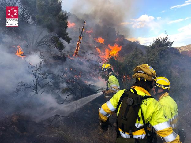 Tres bomberos en las labores de extinción del incendio que afectó al término de Montán. / bomberos de castellón