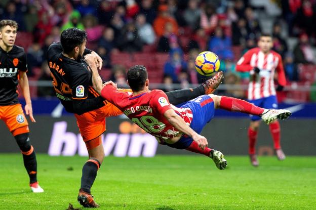 Garay arrebata el balón a Diego Costa durante el Atlético-Valencia. / EFE/Rodrigo Jiménez