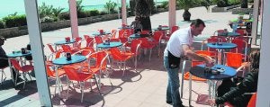 Un camarero sirve un refresco a una cliente en el Paseo Marítimo del Puerto de Sagunto hace unas semanas. ::
LP/