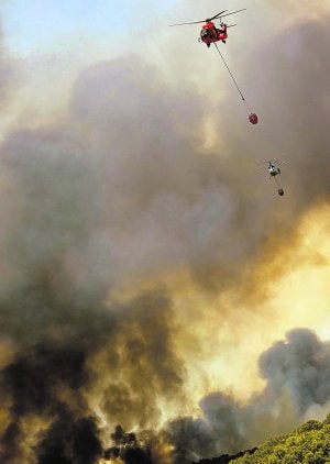 Apoyo aéreo. Dos helicópteros combaten el fuego en Alcublas. ::
DAMIÁN TORRES/