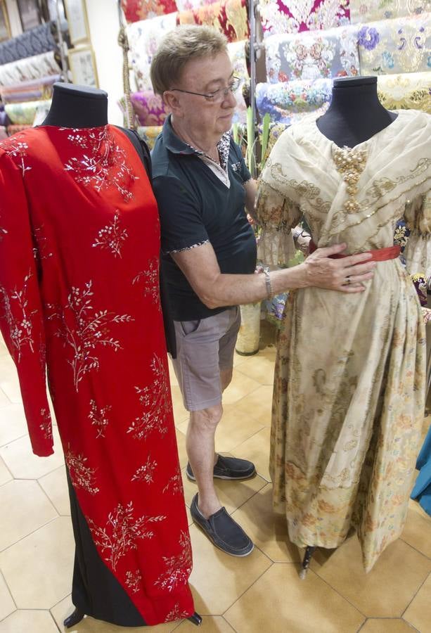 Enrique Marzal, en su taller, con unos vestidos antiguos para restaurar